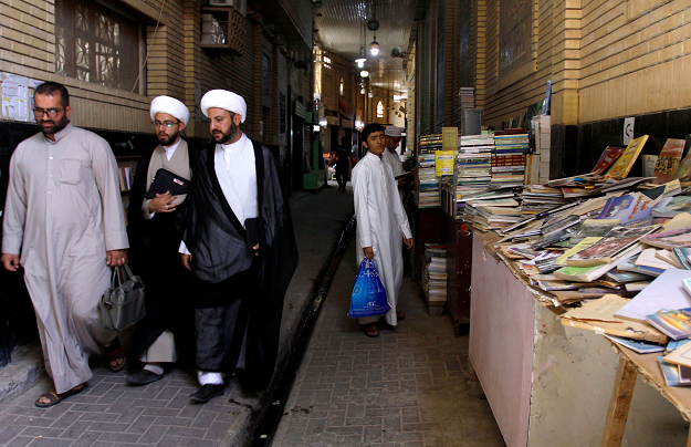 iraqi-muslim-religious-men-walk-at-the-howeish-book-market-afp-1539149588